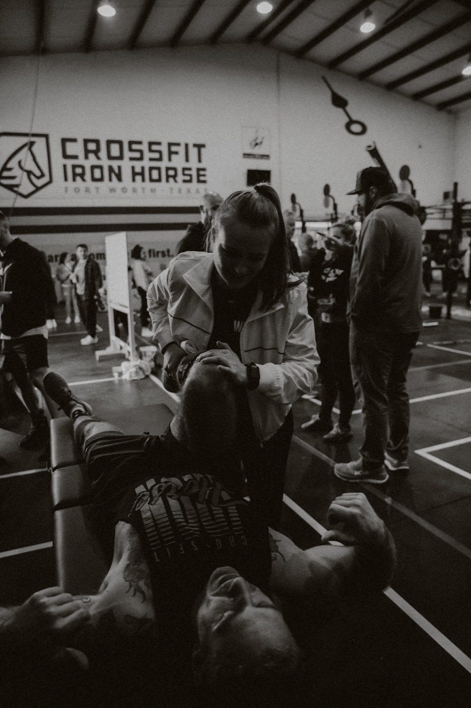 A WLF staffer working on an athlete's neck and shoulders on a treatment table at a community event.