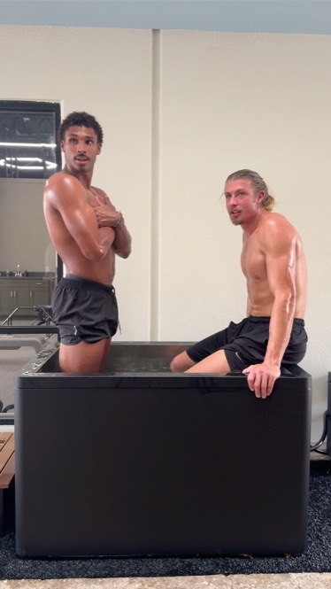 Two members in the cold plunge at WLF Club.
